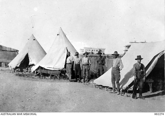 AWM Photo H02274 SUEZ CANAL AREA, EGYPT. C. 1915. SIX AUSTRALIAN SOLDIERS OUTSIDE TENTS ON THE EDGE OF MOASCAR CAMP. (DONOR A.M. MEENAH)